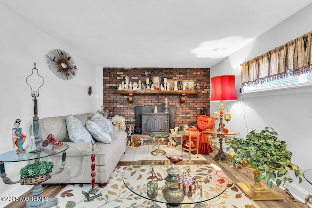 living room featuring wood finished floors and a wood stove