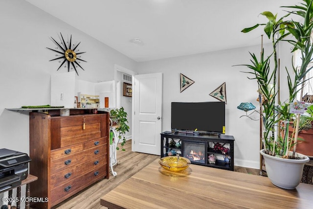 living area featuring wood finished floors and baseboards