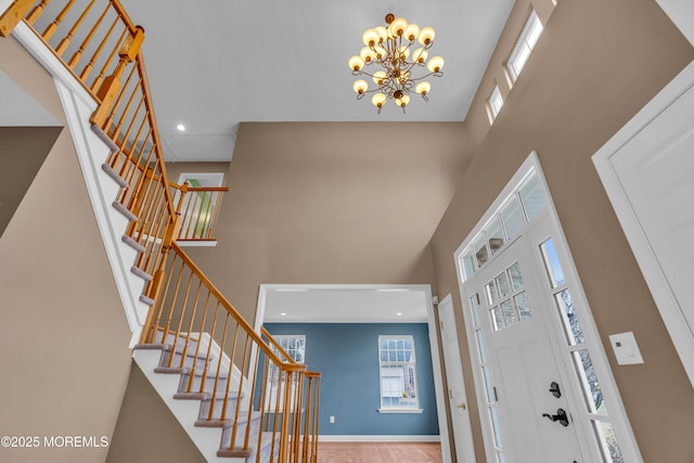 foyer entrance featuring recessed lighting, baseboards, a high ceiling, and stairs