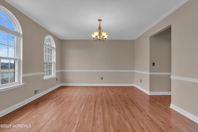 unfurnished room with visible vents, baseboards, a notable chandelier, and light wood-style flooring