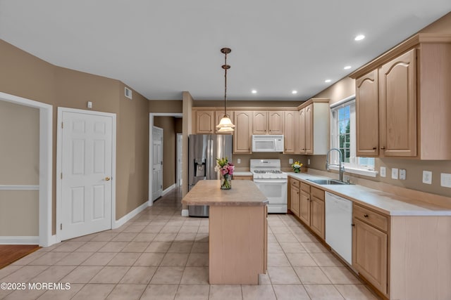 kitchen with light brown cabinetry, a sink, a center island, white appliances, and light countertops