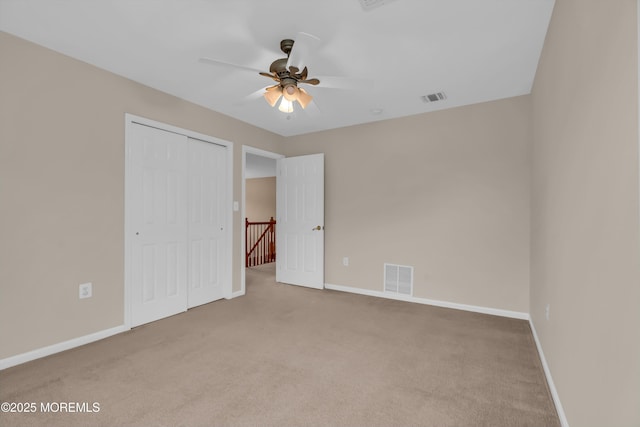 unfurnished bedroom featuring a closet, baseboards, visible vents, and carpet floors