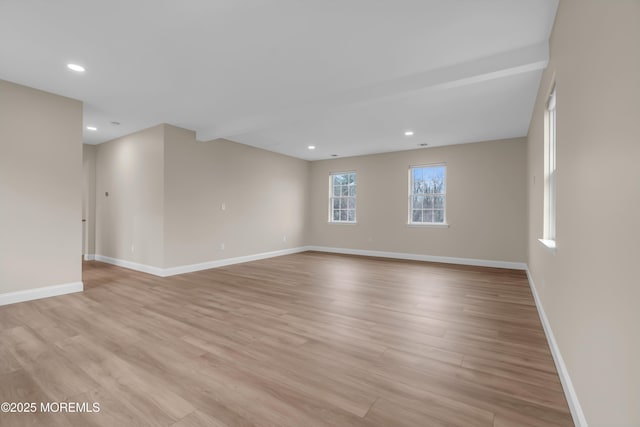 unfurnished room featuring recessed lighting, light wood-type flooring, and baseboards