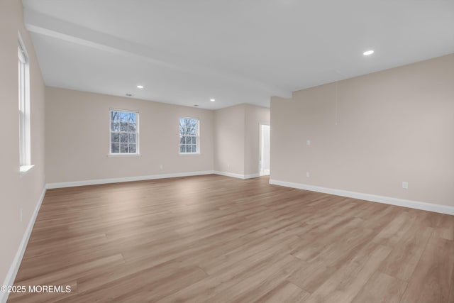 spare room with recessed lighting, baseboards, and light wood-style floors