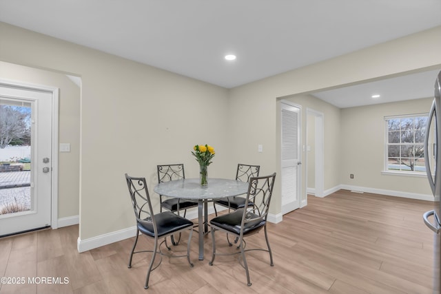 dining space with recessed lighting, baseboards, and light wood finished floors