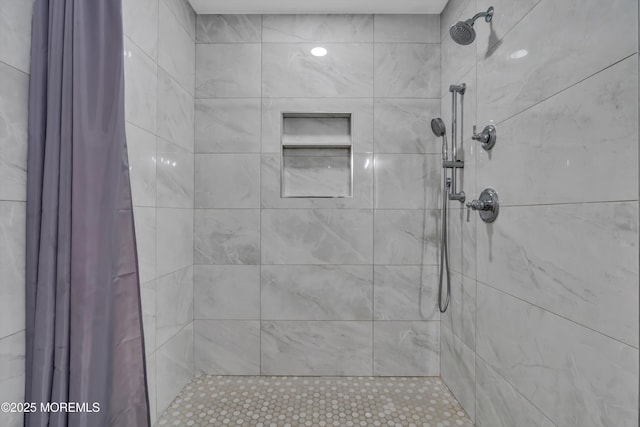 full bath featuring a tile shower