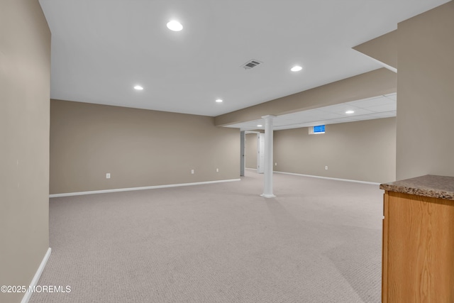 finished below grade area with light carpet, recessed lighting, and baseboards