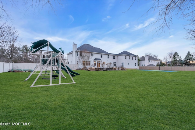 exterior space featuring a lawn, a playground, and a fenced backyard