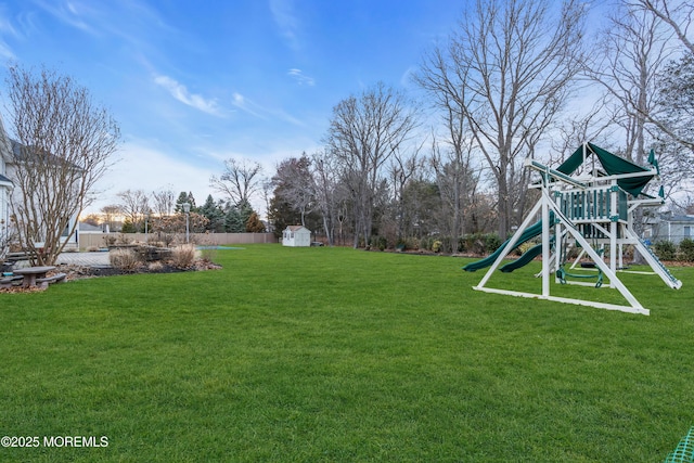 view of yard with an outbuilding, a storage shed, and a playground