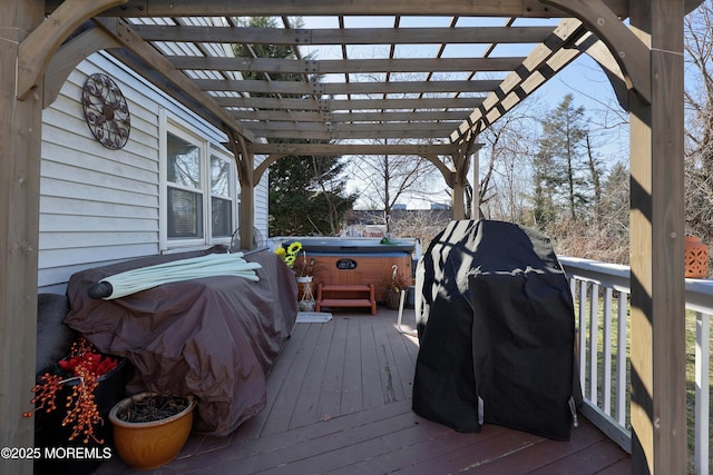 wooden deck with grilling area, a pergola, and a hot tub