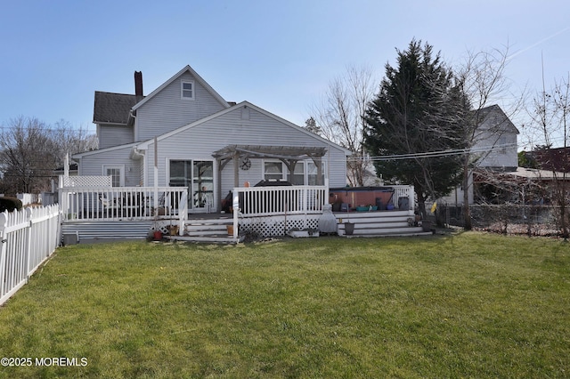 back of property with a yard, a wooden deck, a fenced backyard, and a pergola