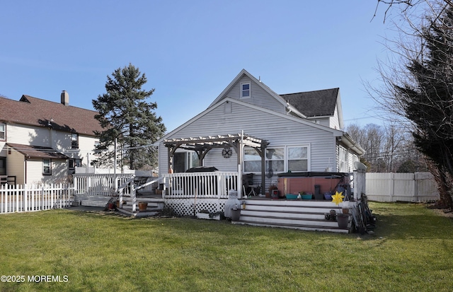 back of property with a deck, a pergola, fence, a yard, and a hot tub