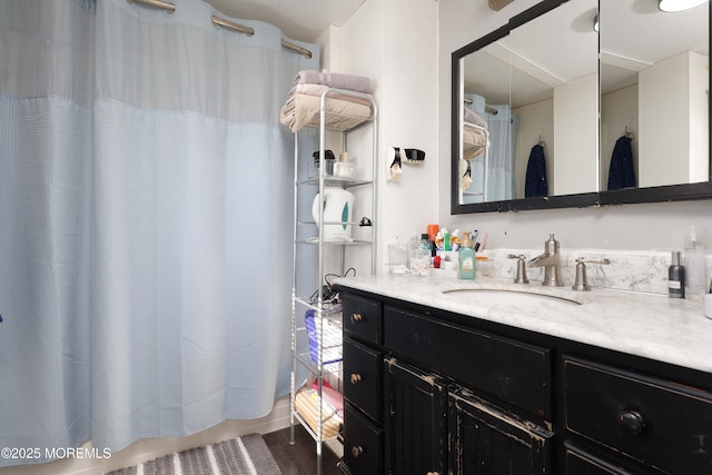 bathroom featuring vanity and curtained shower