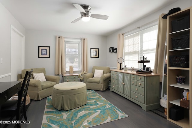 sitting room featuring a ceiling fan and dark wood-style flooring