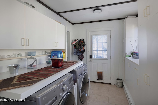 clothes washing area with light tile patterned floors, cabinet space, washing machine and dryer, and crown molding