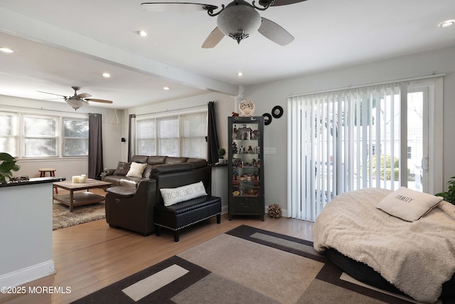 bedroom featuring access to exterior, beamed ceiling, recessed lighting, and light wood-style floors