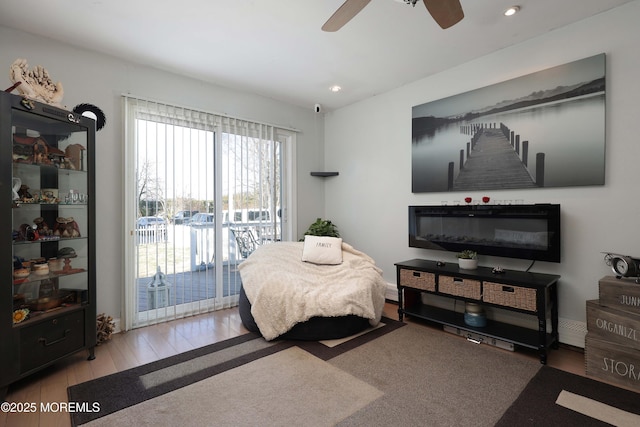 bedroom featuring ceiling fan, wood finished floors, recessed lighting, and access to exterior