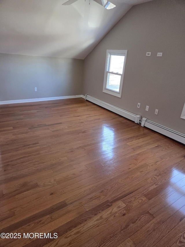 bonus room with a ceiling fan, vaulted ceiling, wood finished floors, and a baseboard radiator