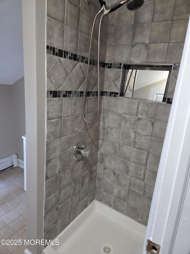 bathroom featuring tiled shower and baseboard heating