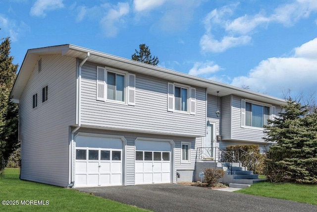 bi-level home with a garage and driveway