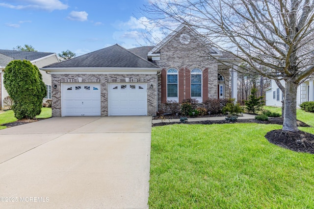 view of front of property with a shingled roof, concrete driveway, a front yard, an attached garage, and brick siding