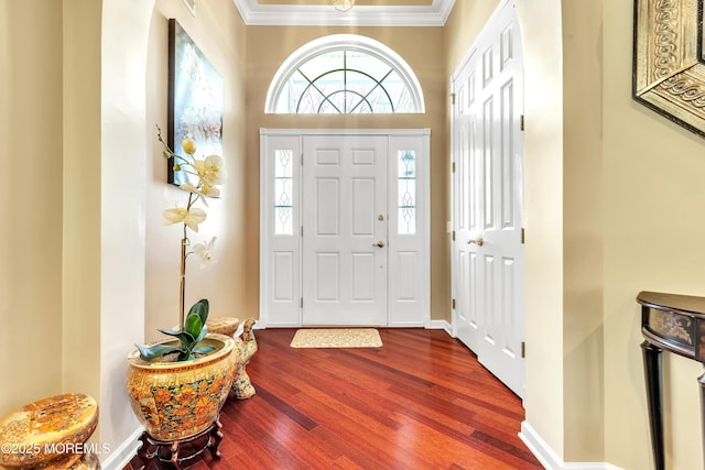 entryway with baseboards, dark wood finished floors, and crown molding