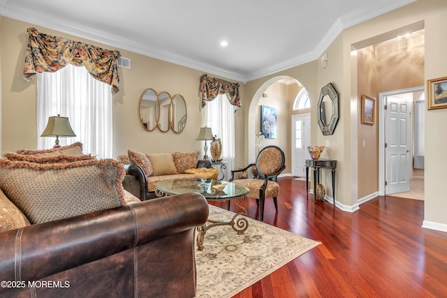 living room with arched walkways, crown molding, baseboards, and dark wood-style flooring