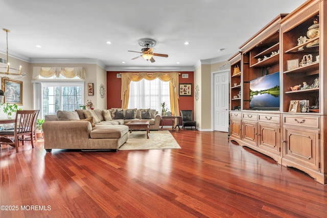 living area featuring dark wood-style floors, recessed lighting, and ornamental molding