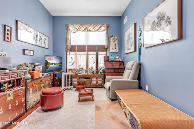 sitting room featuring visible vents and radiator