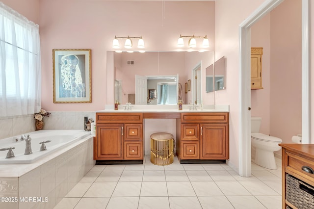 bathroom featuring tile patterned floors, visible vents, toilet, a garden tub, and vanity