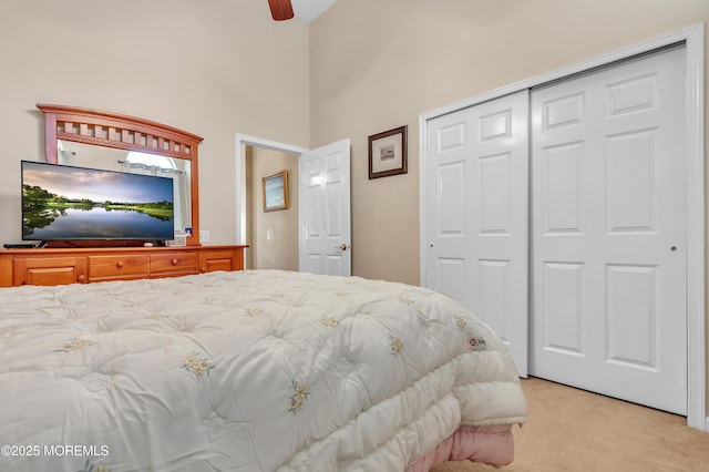 bedroom featuring light colored carpet and a closet