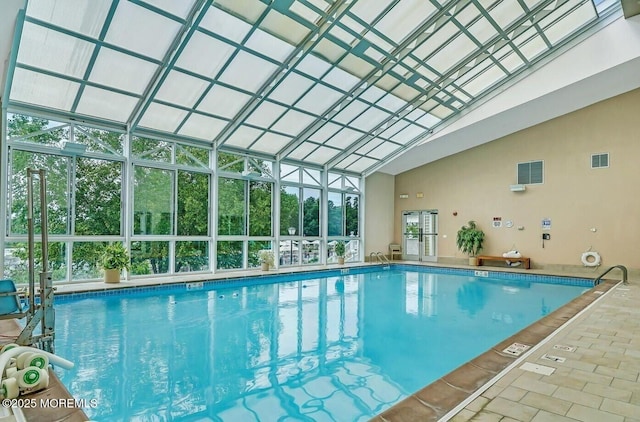 community pool with glass enclosure and a patio