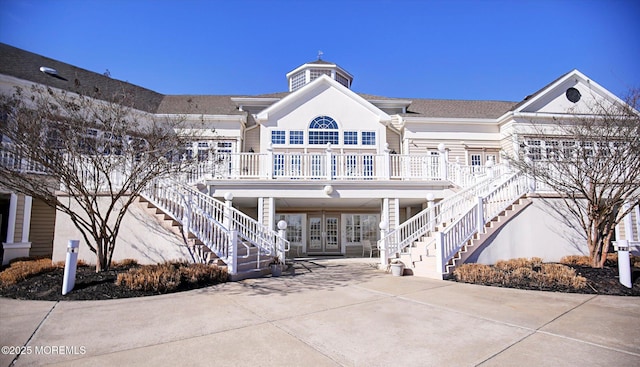 view of property featuring stairway, a carport, and driveway