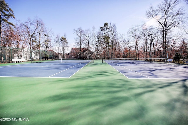 view of tennis court featuring fence