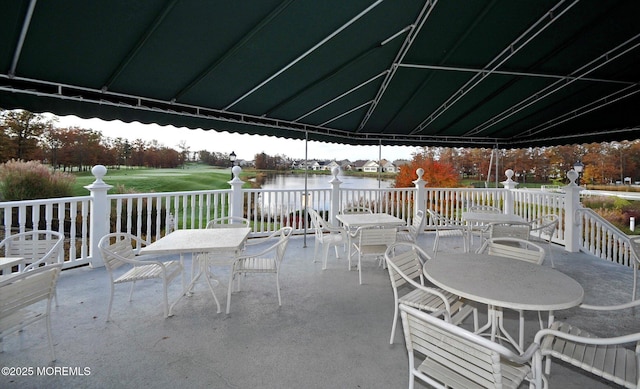 view of patio featuring outdoor dining space and a water view