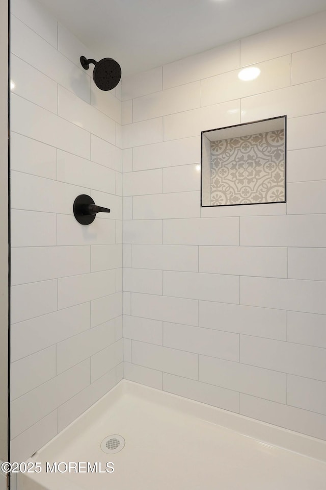 bathroom with a tile shower