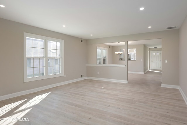 unfurnished living room with visible vents, baseboards, a chandelier, recessed lighting, and light wood-style floors