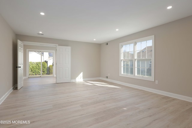 empty room with recessed lighting, baseboards, and light wood-style floors