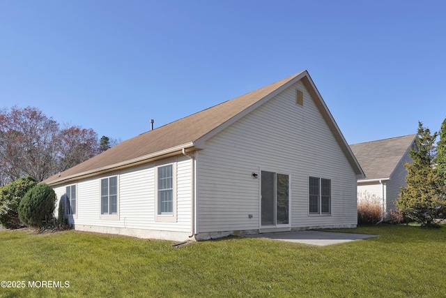 back of property with a patio and a lawn