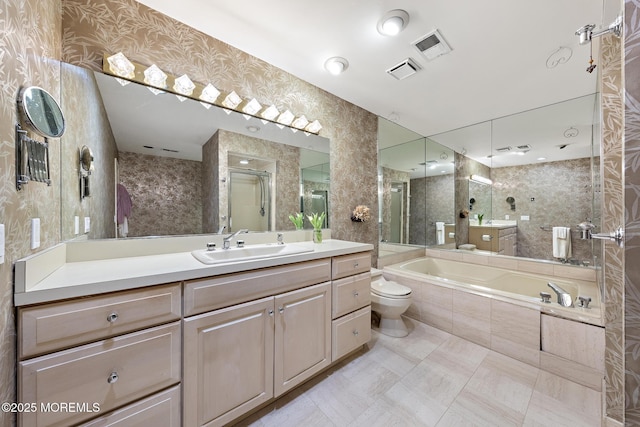 full bath with visible vents, a stall shower, vanity, and a garden tub