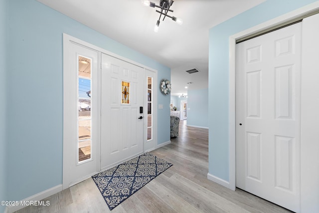 entrance foyer featuring visible vents, light wood-style flooring, and baseboards