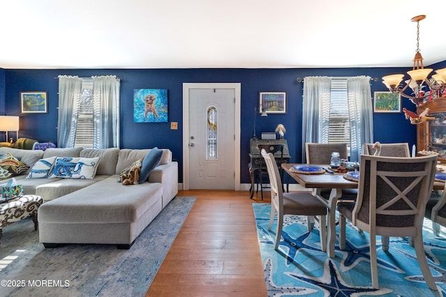 dining area featuring hardwood / wood-style flooring and a notable chandelier