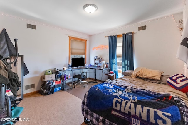 bedroom featuring baseboards and visible vents