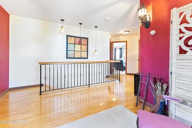 interior space featuring baseboards and wood finished floors