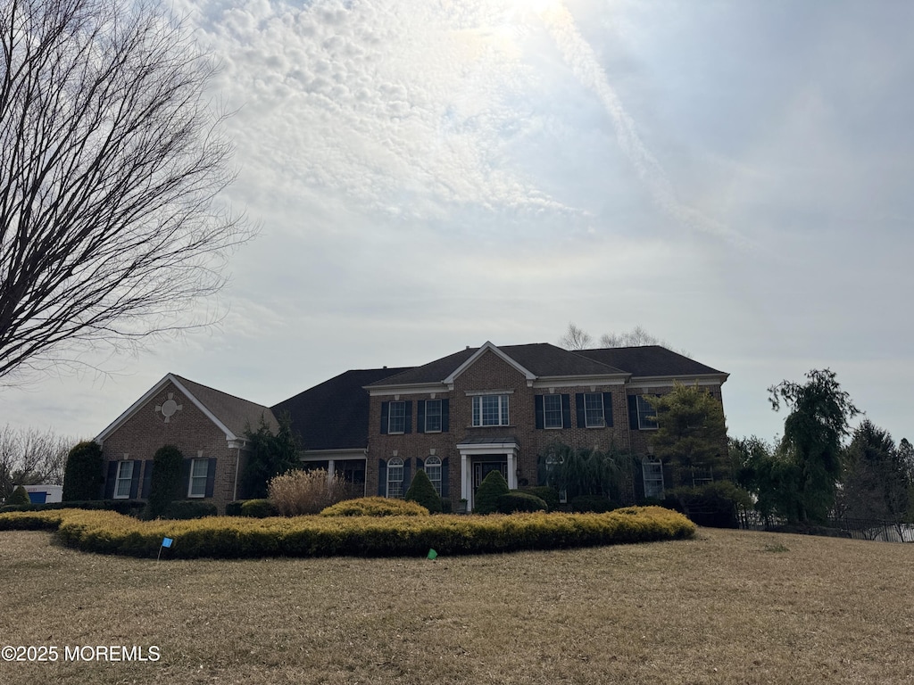 view of front of house featuring brick siding