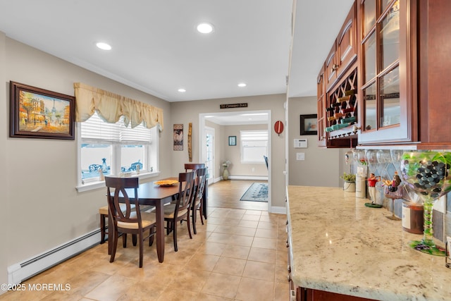 dining space featuring light tile patterned flooring, baseboard heating, a healthy amount of sunlight, and recessed lighting