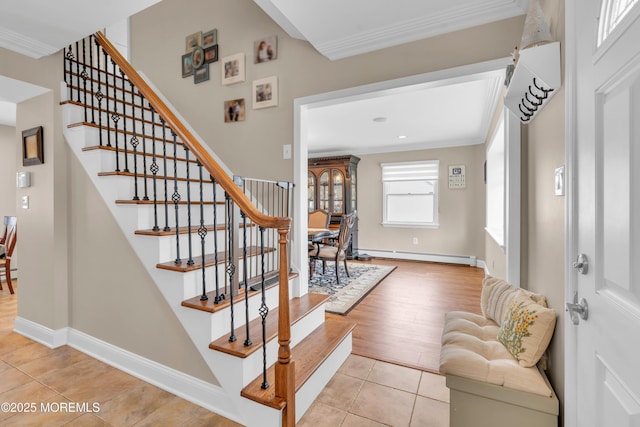 tiled entrance foyer with ornamental molding, stairs, baseboards, and a baseboard radiator