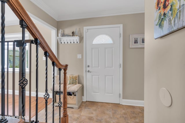 foyer entrance featuring stairs, baseboards, and ornamental molding