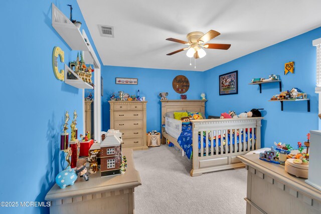 bedroom with visible vents, carpet flooring, and a ceiling fan