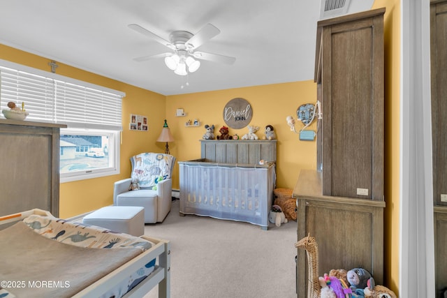 bedroom with visible vents, a ceiling fan, and carpet flooring